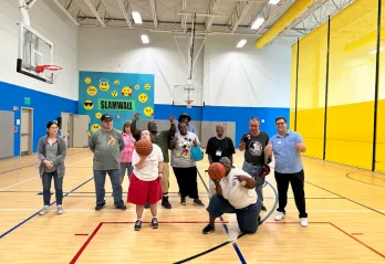group of individuals with disabilities playing basketball