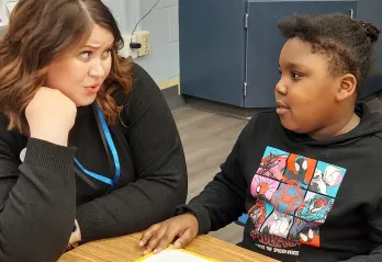 Y Reads Site Coordinator Symphani is pictured working one on one with a student in the program after school at Ferry Pass Elementary.