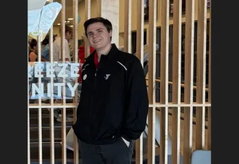 Hunter smiles for a photo in the lobby at the renovated Community YMCA at Gulf Breeze.