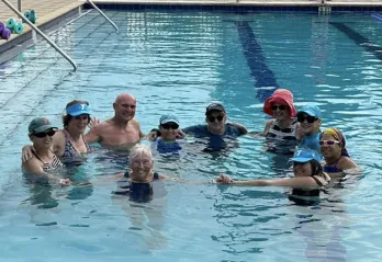 A group gathers in a circle in the pool at the Betty J. Pullum Family YMCA.