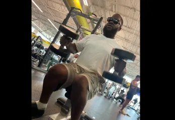 Joshua, member of the Bear Levin Studer YMCA, works with weights on the wellness floor in the branch.