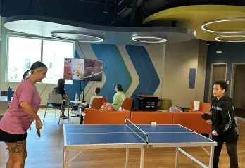 A group from Teen Camp enjoys some game time in the new community room at the Bear Levin Studer YMCA.