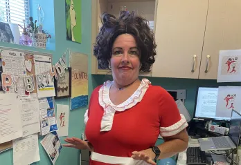 Executive Branch Director Autumn strikes a comedic pose while wearing a costume, celebrating her recent birthday in style.