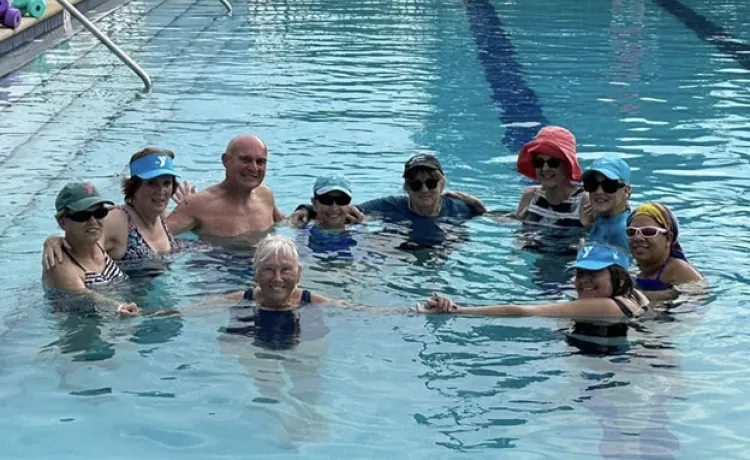 A group gathers in a circle in the pool at the Betty J. Pullum Family YMCA.