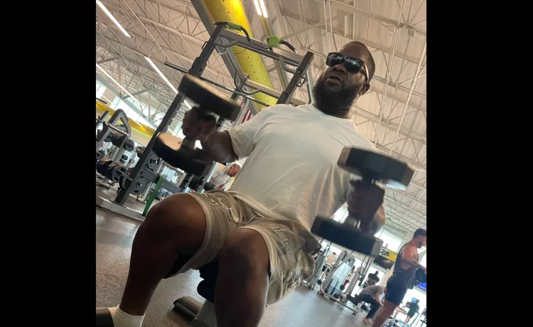 Joshua, member of the Bear Levin Studer YMCA, works with weights on the wellness floor in the branch.