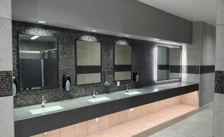 The newly renovated locker rooms and restrooms are pictured with a view of the sink and vanity areas.