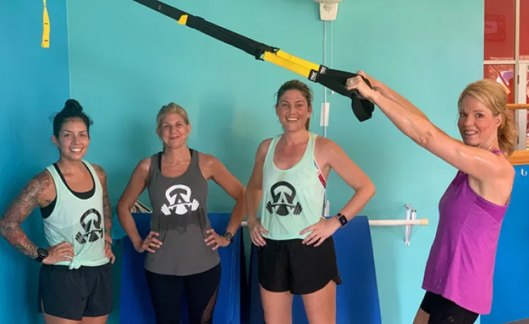 A group participating in Body Challenge at the Betty J. Pullum YMCA encourage each other on the wellness floor.