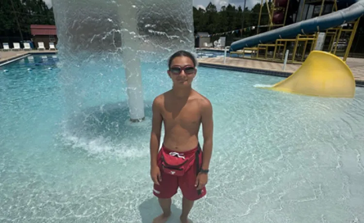 Lifeguard & Swim Instructor William is pictured standing in the shallow end of the pool at the Pullum Y.