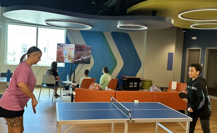 A group from Teen Camp enjoys some game time in the new community room at the Bear Levin Studer YMCA.