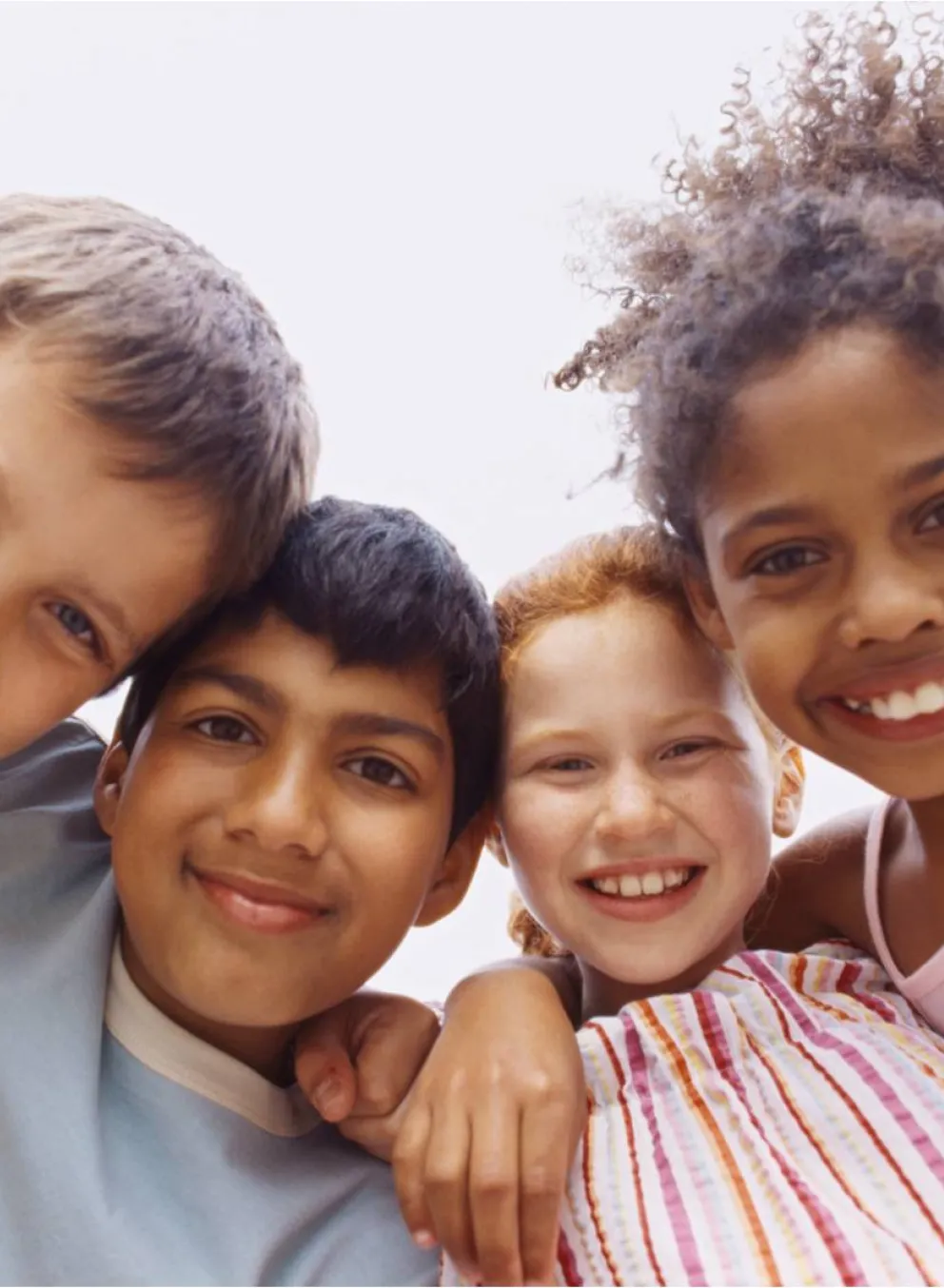 4 kids arm in arm in a huddle