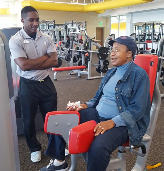 trainer working with senior member