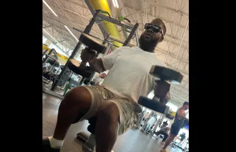 Joshua, member of the Bear Levin Studer YMCA, works with weights on the wellness floor in the branch.